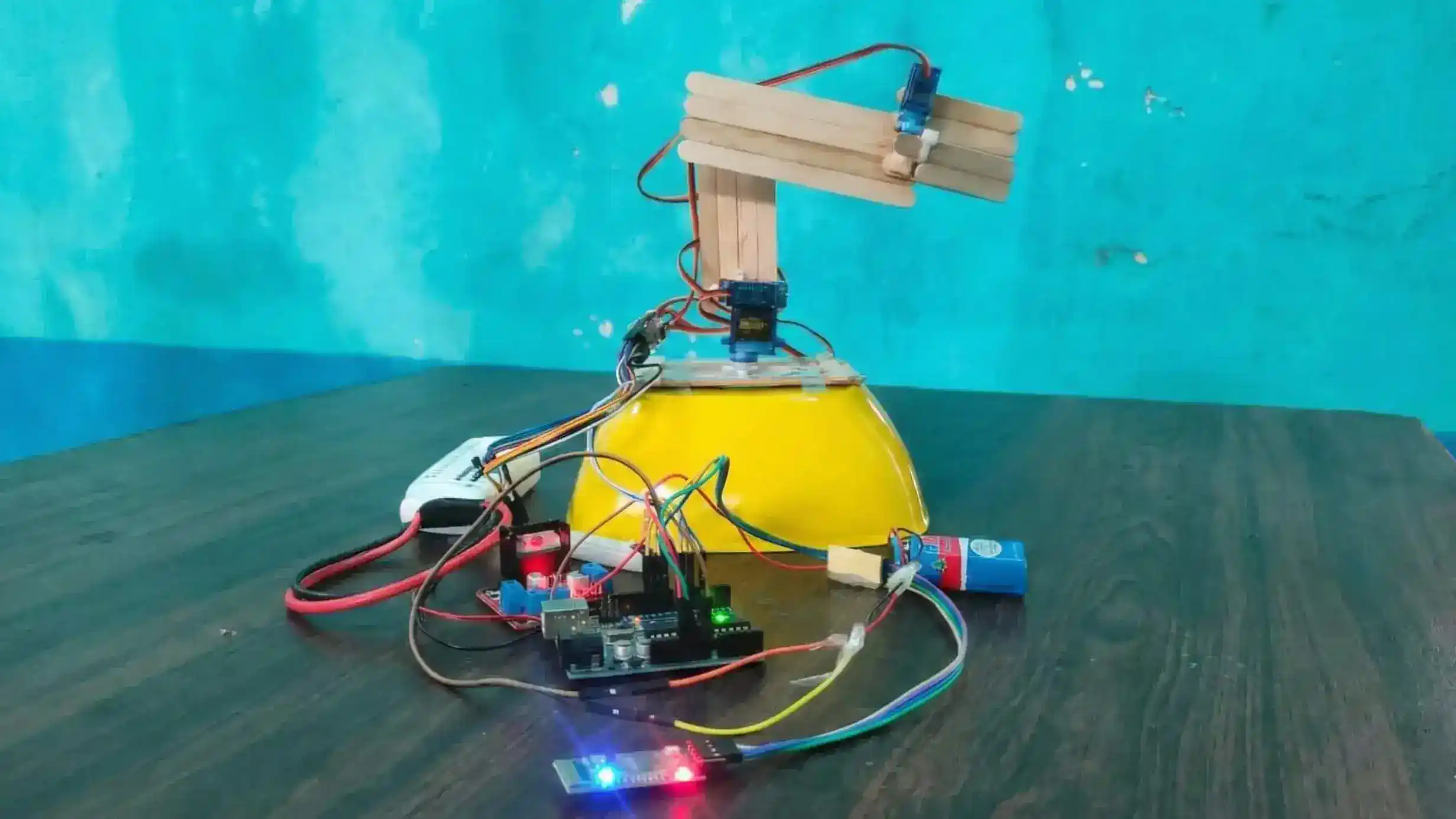 Physical robotic arm hardware connected to servos, controlled via an Arduino serial using bluetooth.